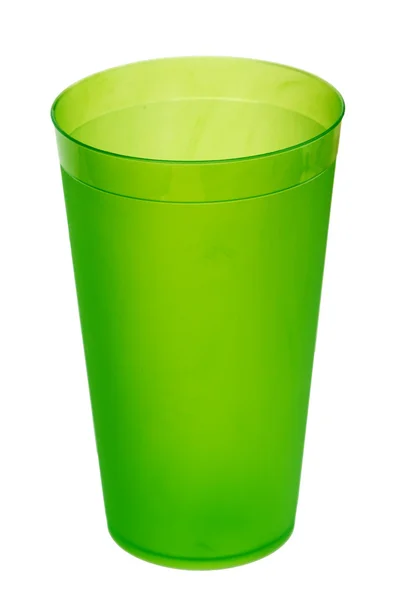 Green plastic glass for juice, isolated on white background. — Stock fotografie